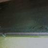 Detail of drain holes in hemmed lower edge of inserts